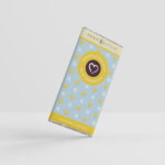 A Lemon and sea salt flavoured milk chocolate bar on one corner as if pivoting against a white background