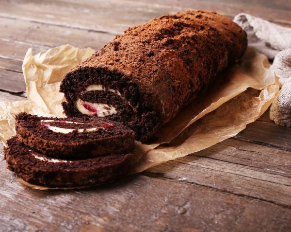 An image of a chocolate & strawberry roulade on a plate