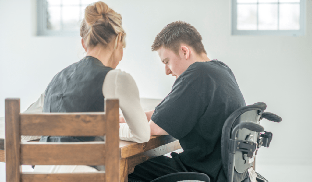 A women talking to a man in a wheelchair