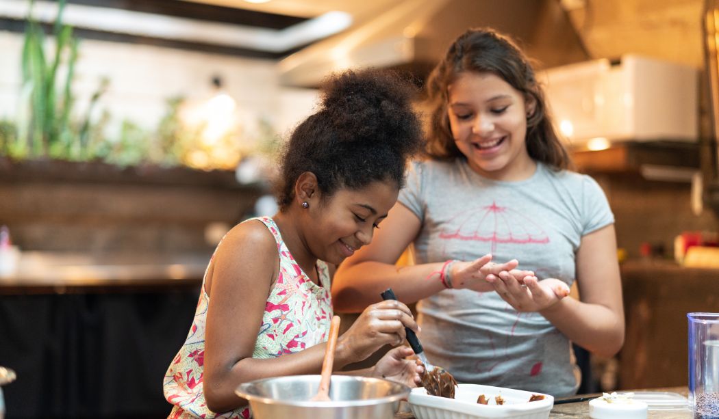 Two young girls baking