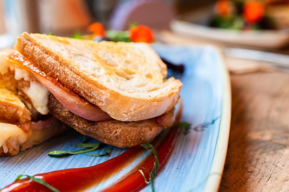 A toasted bacon, cheese and chocolate sandwich on a plate